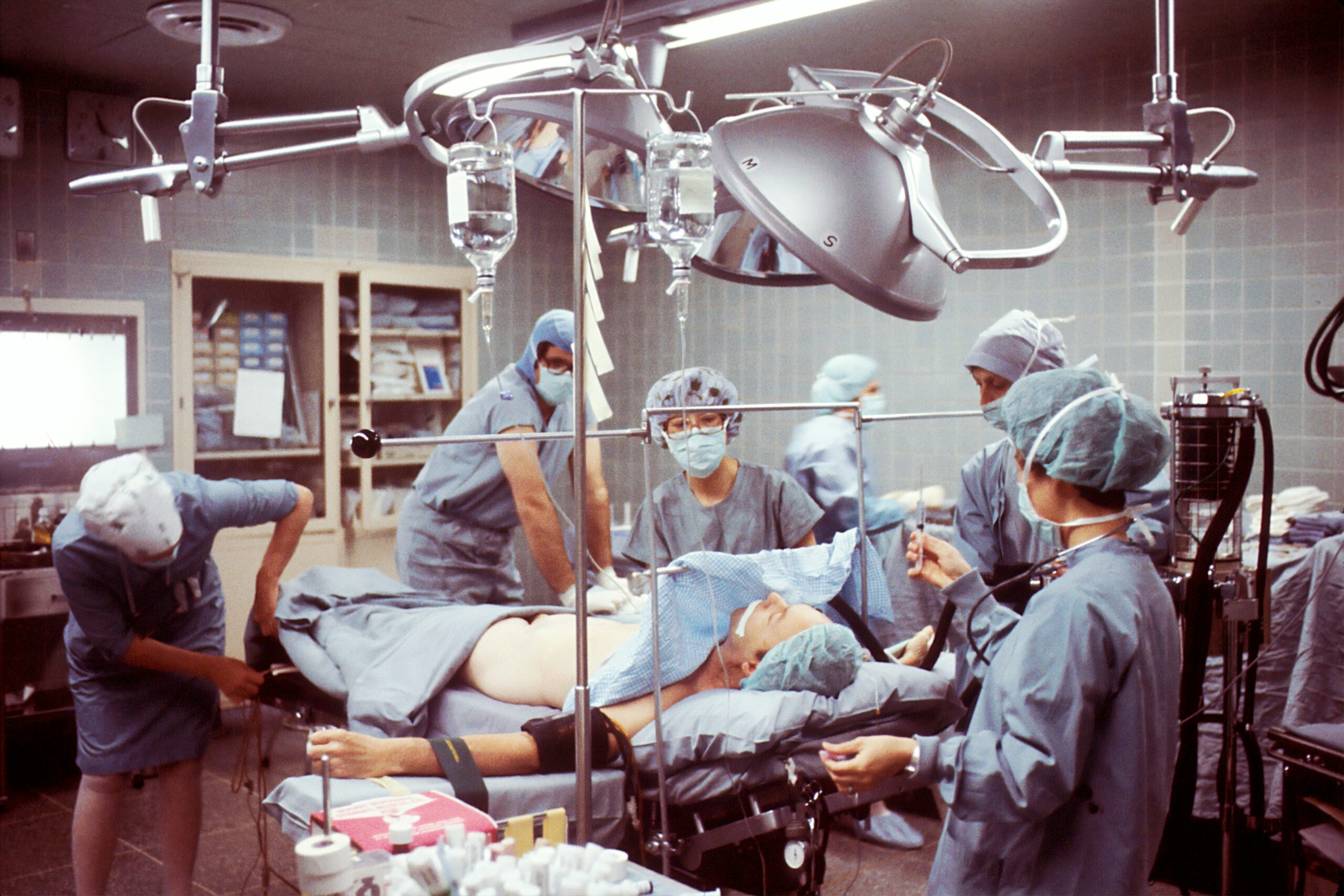 Medical team performing a surgical procedure in an operating room, showing advanced healthcare technology and patient care.